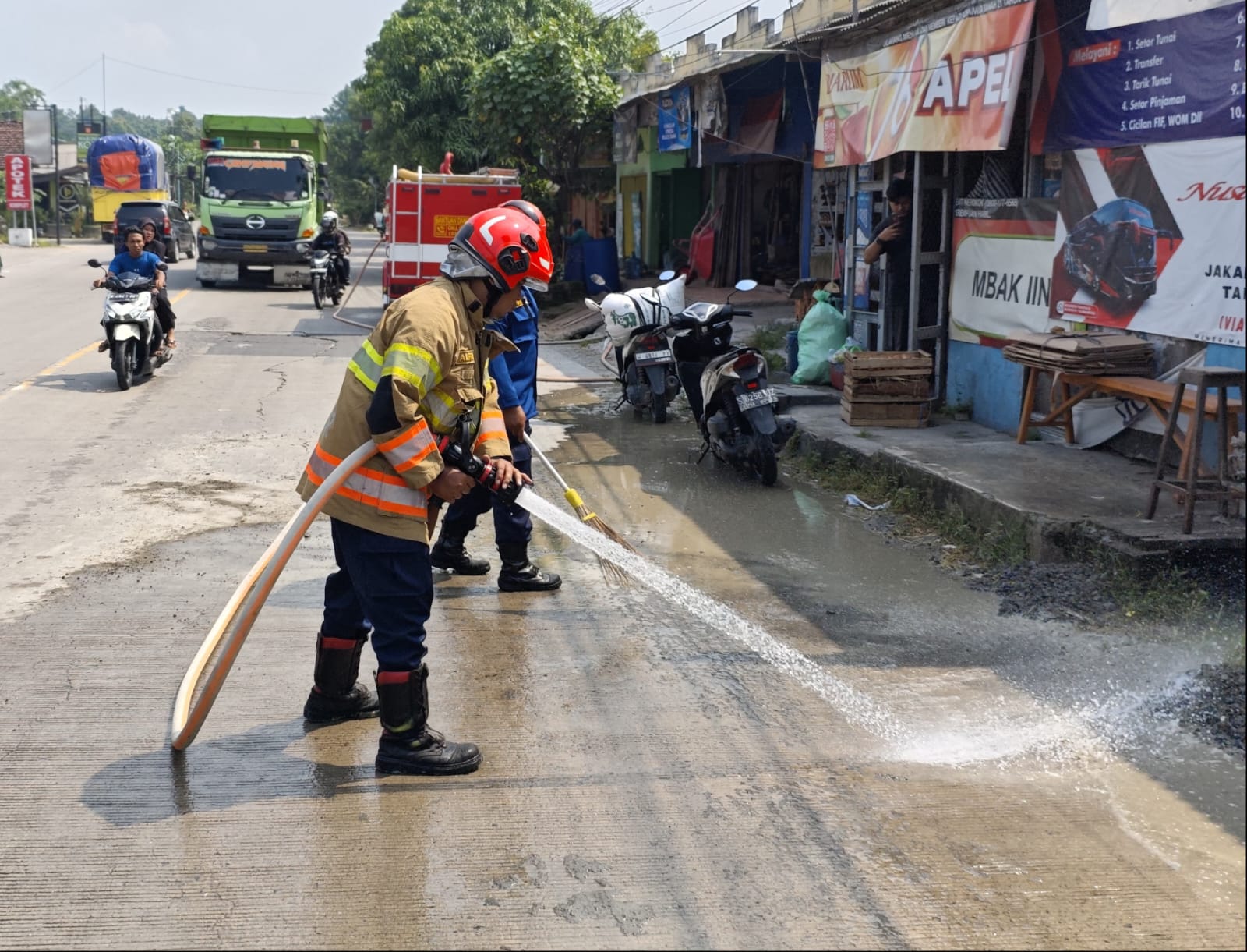 Damkar Ngraho Lakukan Penyemprotan Tumpahan Cor di Jalan Raya Bojonegoro–Ngawi